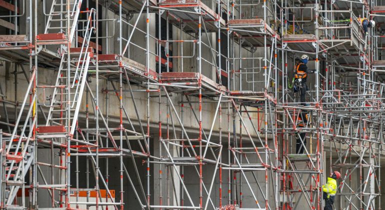 Scaffolding on a building facade with workers