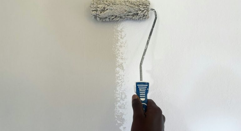 Painting a wall white with a roller